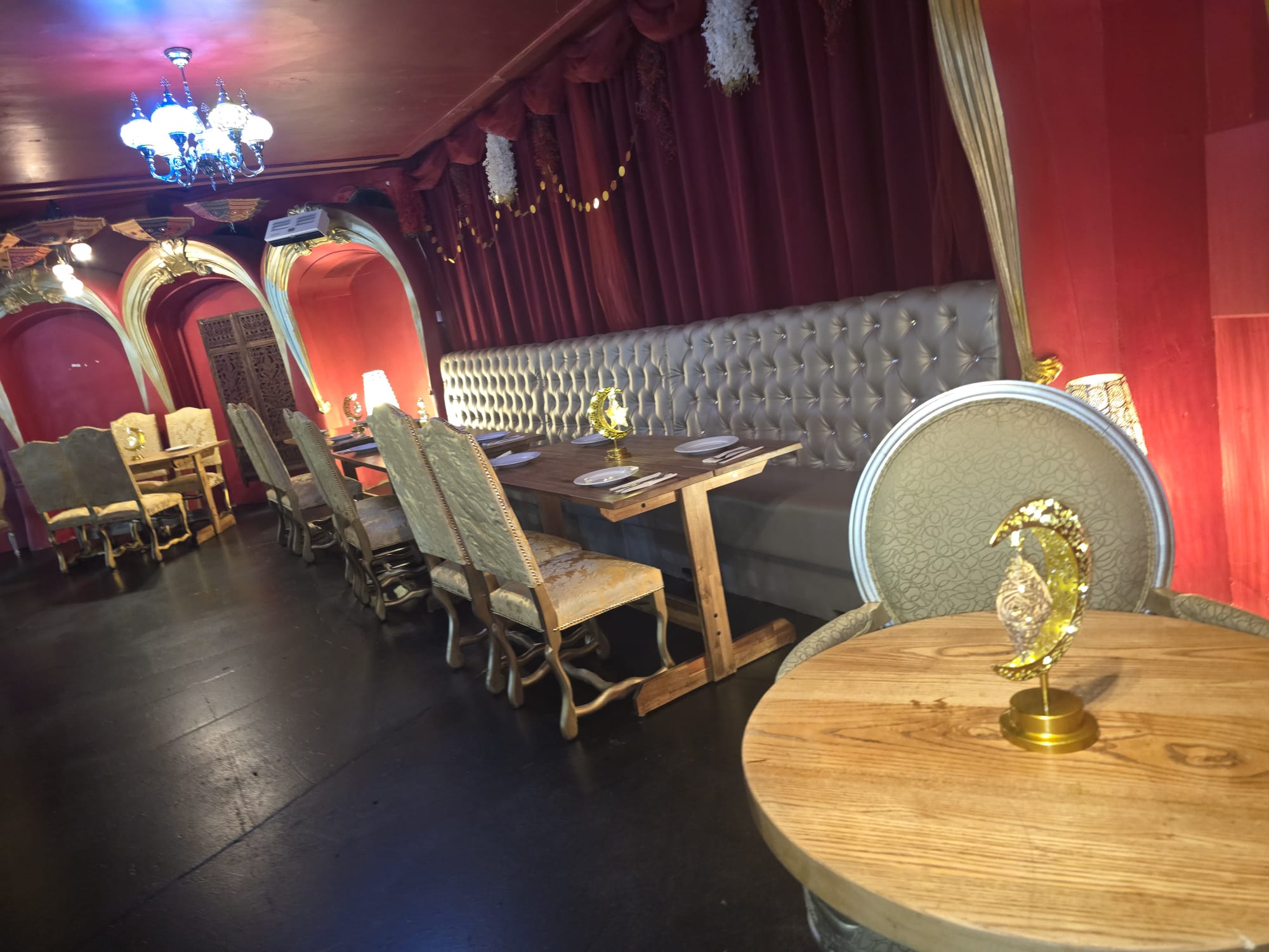 Private velvet banquette dining booth at Opulent @ 35 Liverpool with tufted seating, chandeliers and Fozia's restaurant styling